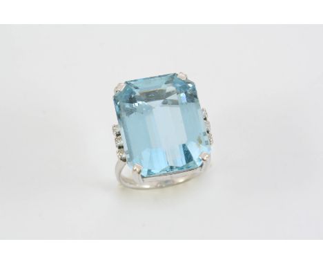 AN AQUAMARINE AND DIAMOND RING the step-cut aquamarine is set with three circular-cut diamonds to each shoulder, in white gol