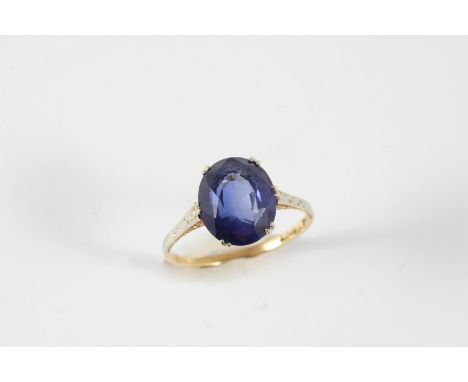 A SYNTHETIC SAPPHIRE SINGLE STONE RING the oval-shaped synthetic sapphire is set in gold. Size K 1/2.