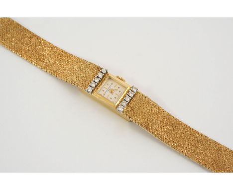 A LADY'S 18CT. GOLD AND DIAMOND WRISTWATCH BY BAUME &amp; MERCIER the signed square-shaped dial with dot and baton numerals, 