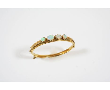 AN OPAL AND GOLD HALF HINGED BANGLE the 15ct. gold bangle set to one side with two oval-shaped and two circular-shaped solid 