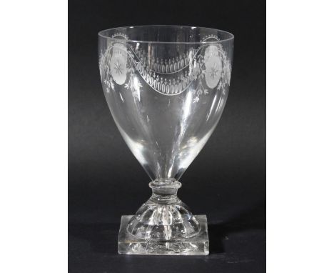 GLASS GOBLET, circa 1800, the tapering bowl with engraved oval and swag decoration, knopped, short stem and lemon squeezer fo