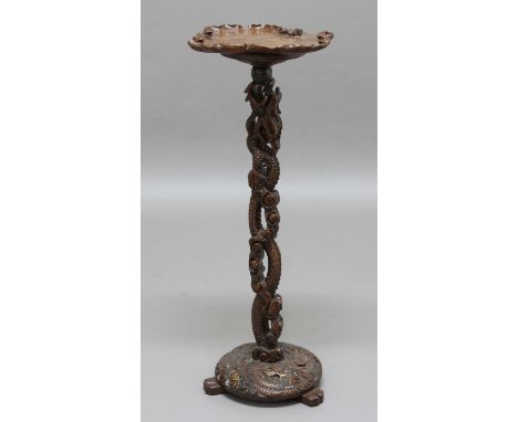 CHINESE CARVED LAMP TABLE, 19th century, the leaf-shaped top with insects above a pierced stem and base carved with dragons, 