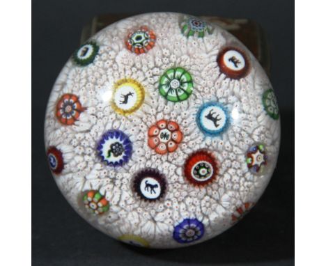 BACCARAT CARPET GROUND PAPERWEIGHT, dated 1848, a central cluster with a butterfly surrounded by six canes including three si