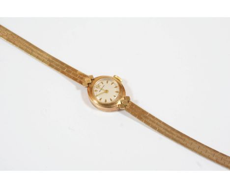 A LADY'S 9CT. GOLD WRISTWATCH BY GARRARD the signed circular dial with dagger numerals and one Arabic numeral at 12 o'clock, 