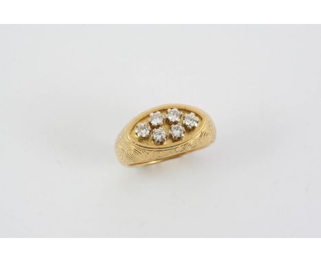 A DIAMOND AND GOLD RING BY GERALD BENNEY the 18ct. gold mount with engraved swirl decoration and set with six circular-cut di