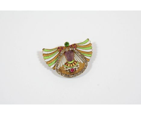 A VICTORIAN EGYPTIAN REVIVAL ENAMEL AND GEM SET BROOCH the central figure with carved amethyst face, with green and brown ena