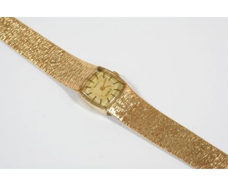 A LADY'S 9CT. GOLD WRISTWATCH the cushion-shaped dial signed Geneve and with baton numerals, quartz movement, on an integral 