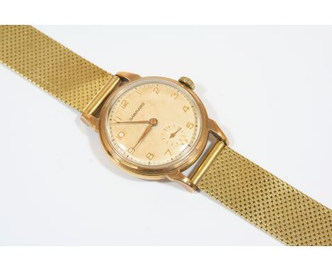 A GENTLEMAN'S GOLD WRISTWATCH BY GARRARD the signed circular dial with Arabic numerals and subsidiary seconds dial, with pres
