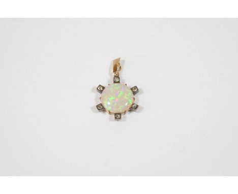 AN OPAL AND DIAMOND PENDANT the circular solid white opal is set within a gold surround mounted with six rose-cut diamonds in