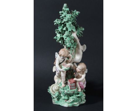 DERBY PATCH MARK FIGURE GROUP, late 18th century, modelled as four cherubs catching birds around a tree, on a rocky base, inc