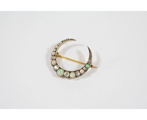 A VICTORIAN DIAMOND AND OPAL CLOSED CRESCENT BROOCH formed with graduated circular solid white opals and old brilliant-cut an