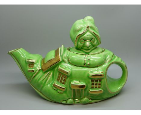 A Lingard Pottery 1930 'Old Lady Who Lived In A Shoe' teapot, very small chip to the spout 