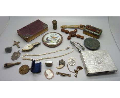 A carved cross pendant, a novelty champagne bottle cigar cutter, a/f, a carved Figa hand or fist, a Romanian medallion, a pai