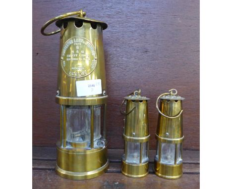 An Eccles miner’s safety lamp and two smaller lamps 