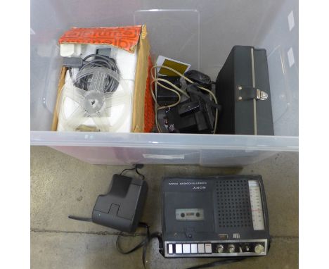 A collection of camera related equipment including a cine camera, light exposure instrument, projector, tape recorder, camera