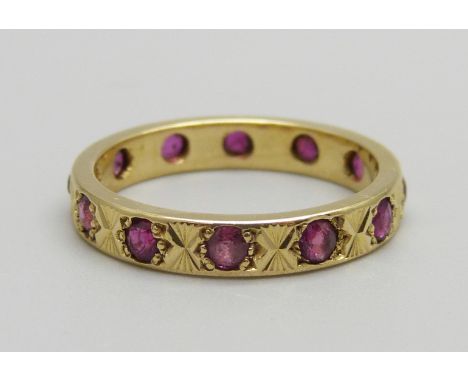 An 18ct gold and ruby eternity ring, 4.2g, P 