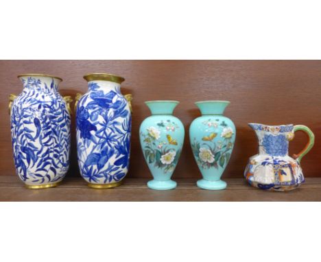 A pair of glass vases decorated with flowers and butterflies, a Davenport jug and two similar blue and white vases, one with 