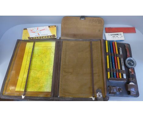 A Soviet map case, with pencils, wrist compass and maps 