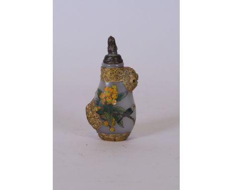 A Chinese glass snuff bottle with gilt and carved mask decoration, polychrome enamel painted decoration of birds and butterfl