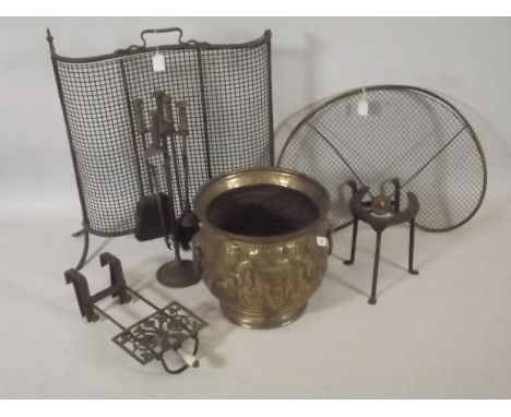 A brass coal bucket with embossed coat of arms decoration and lion's mask ring handles, together with two fire guards and a c
