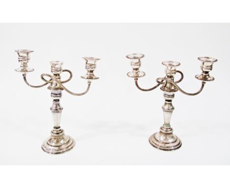 A pair of 20th Century silver plated three light candelabra, each with shaped square detachable nozzles to urn-shaped sconces