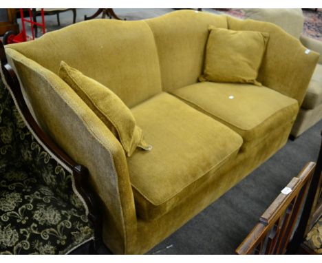 A feather filled two-seater knoll sofa, modern, upholstered in yellow fabric, with serpentine shaped back support and arms, w