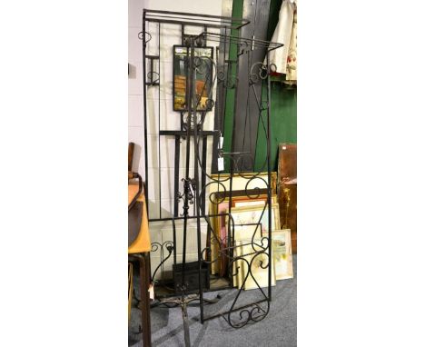 A group of wrought iron furniture comprising two hall stands, two up stands, two stick stands, a wall mounted rack, a light f