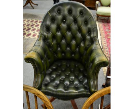 A green leather button backed desk chair 