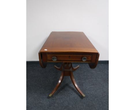 A Victorian inlaid mahogany pedestal sofa table fitted a drawer