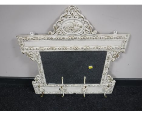 A 20th century cream and gilt mirrored coat rack of Dutch design