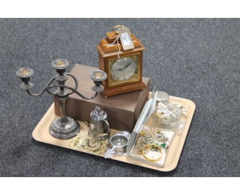 A tray containing a boxed Garrard & Company Elliott mantel clock together with plated wares, table lighter, costume jewellery