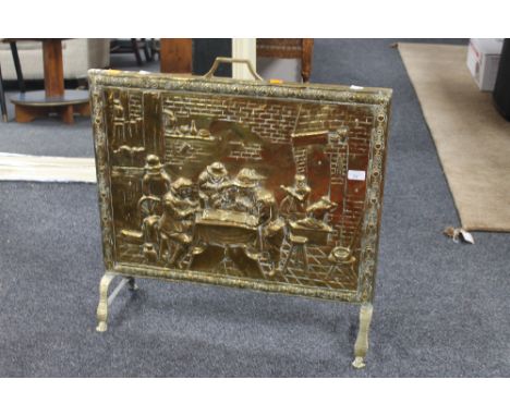 A brass embossed fire screen