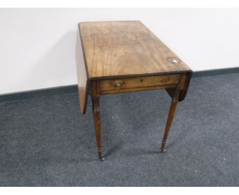 A George III mahogany drop leaf sofa table, on tapered legs terminating in brass castors, width 86 cm