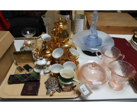 A tray of gilt continental coffee set, Beswick Micawber miniature jug, Festival of Britain coin, vintage Gillette razor, Coal