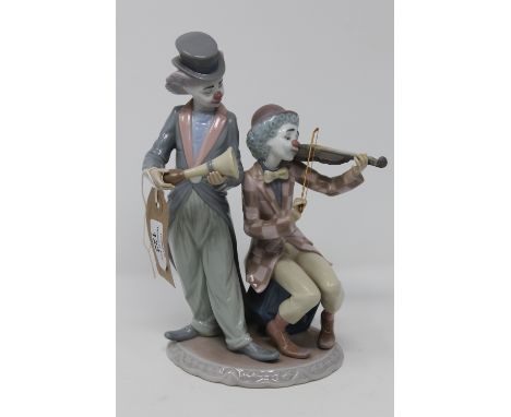 A Lladro figure group - clown playing violin and clown with horn CONDITION REPORT: In good condition with no apparent faults.