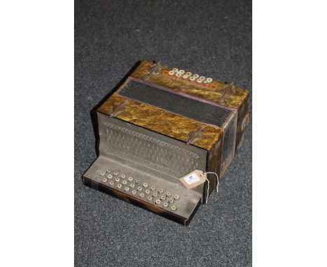 An accordion with mother of pearl buttons 