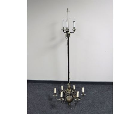 A continental brass and metal three way standard lamp on paw feet together with a six-way light fitting