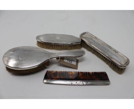 Three silver backed brushes together with a silver edged comb
