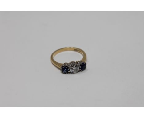 An 18ct gold three stone sapphire and diamond ring, the central stone weighing approximately 0.5 carat, size M CONDITION REPO