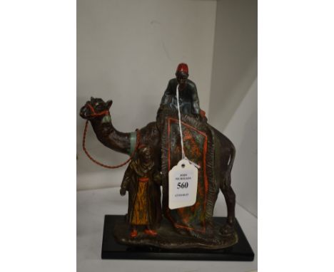 A painted spelter table lighter modelled as Arab carpet sellers on a camel.