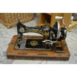A narrow oak bookcase or CD rack and a sewing machine.