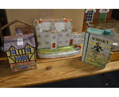 A cottage shaped biscuit jar, Staffordshire flatback figure of Stanfield Hall and a book shaped whisky decanter.