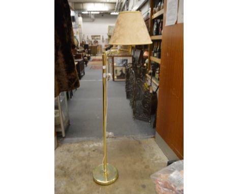 A brass floor standing lamp.