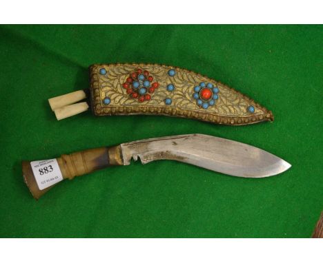A miniature Kukri with decorative scabbard.