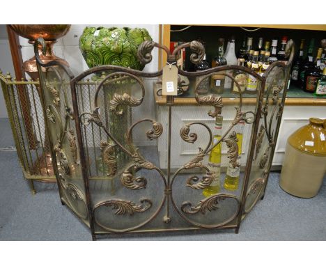 An ornate folding fire screen.