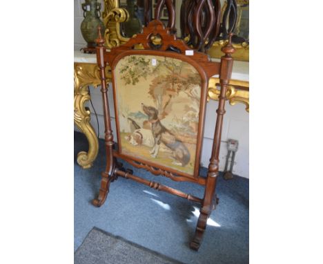 A good Victorian walnut firescreen, the central embroidered panel depicting two dogs.