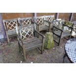 A set of six weathered teak garden armchairs.