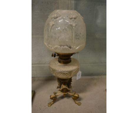 An ornate brass and cut glass oil lamp.