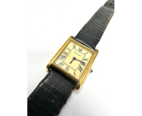 Vintage gents Movado gold tone tank wrist watch hand winding the watch is ticking black leather strap 