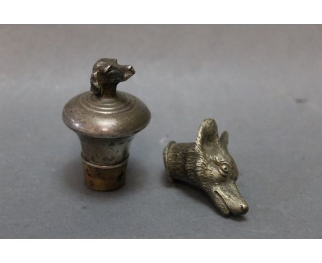 A silver hallmarked bottle stopper, the top decorated with a dogs head, makers mark AJP for AJ Poole, Birmingham, date letter
